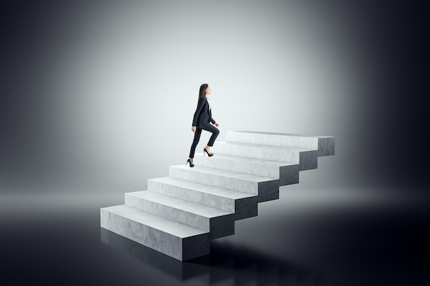 businesswoman climbing concrete steps on a gradient background