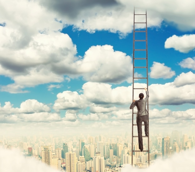 businesswoman climbing the ladder to the sky