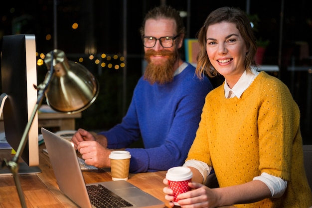 Businesswoman and colleague at their desk