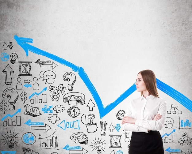 Businesswoman at concrete wall