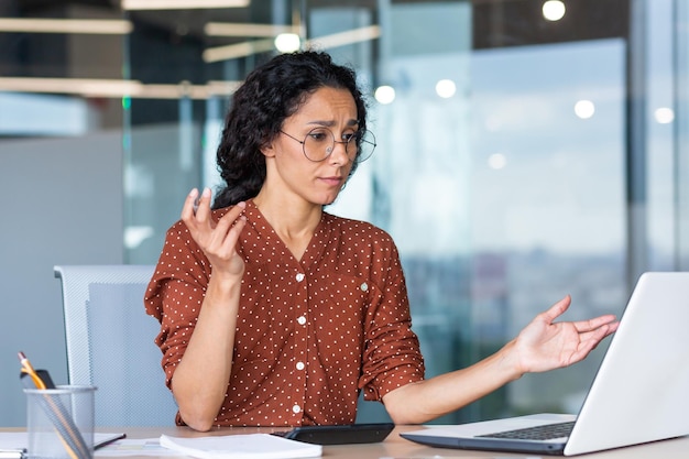 Businesswoman disappointed and sad at work not happy with the\
result of achievement at work hispanic