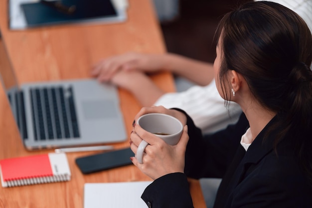 Businesswoman discussing strategy for concept of harmony in office with coffee