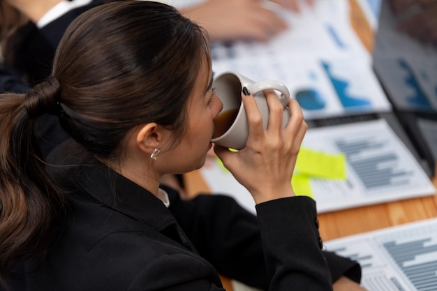 Businesswoman discussing strategy for concept of harmony in office with coffee