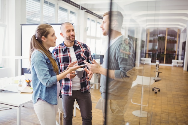 Businesswoman discussing with colleagues in office