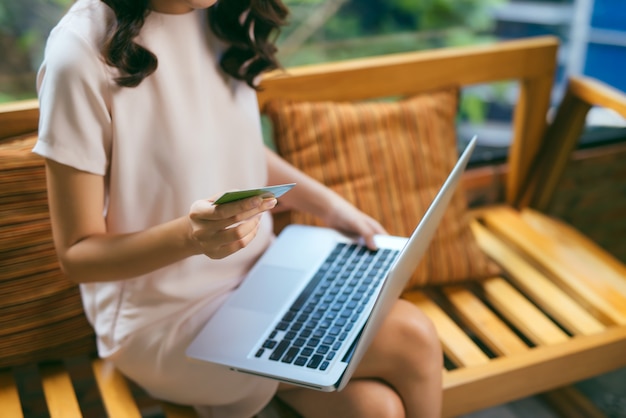 Businesswoman doing online shopping through laptop and credit card