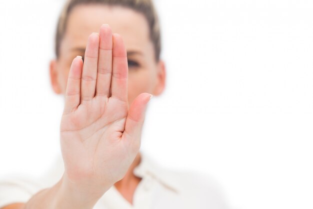 Businesswoman doing stop with palm