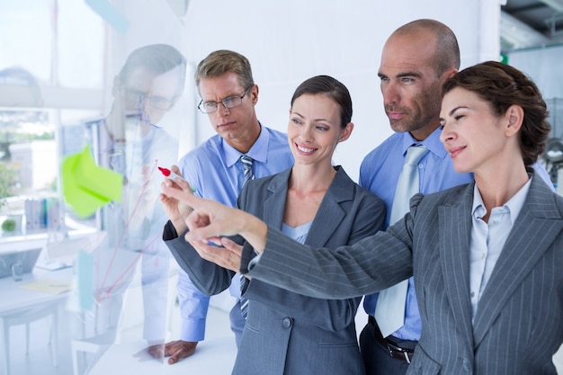 Businesswoman drawing graph on the board