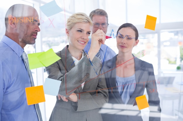 Businesswoman drawing graph on the board