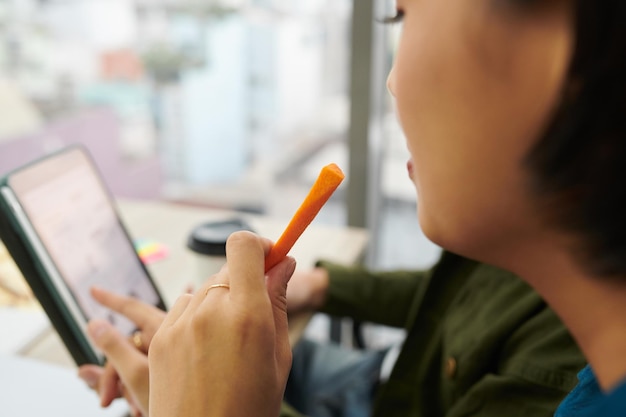 Businesswoman Eating Carrot Stick