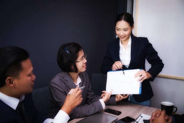 Businesswoman explaining to coworkers in meeting