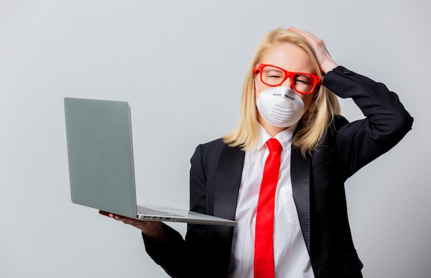 Businesswoman in face mask and red glasses with notebook