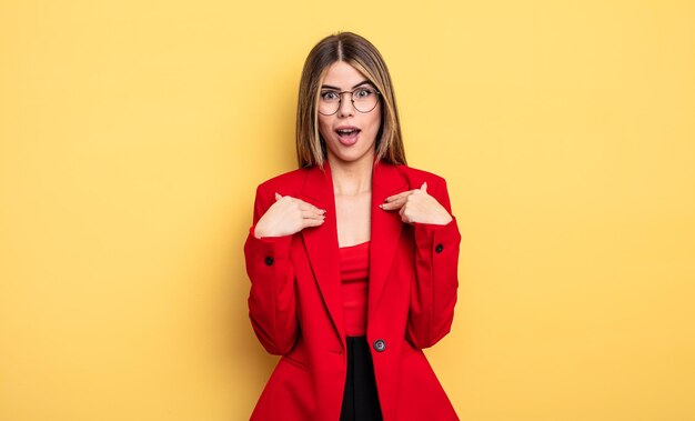 Businesswoman feeling happy and pointing to self with an excited