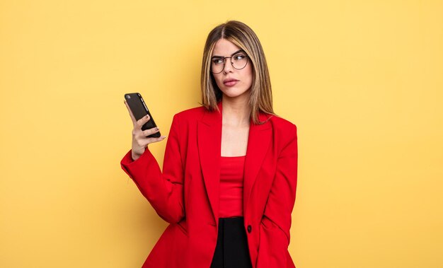 Businesswoman feeling sad upset or angry and looking to the side smartphone concept