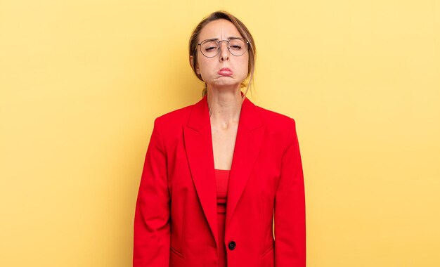 Businesswoman feeling sad and whiney with an unhappy look and crying