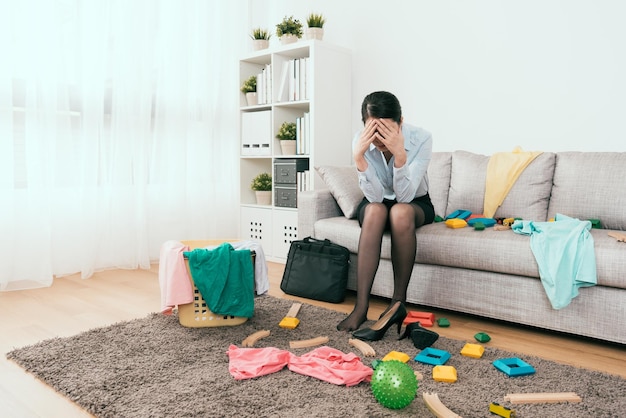 businesswoman feels frustration to see the mess made from her kids after she back from work