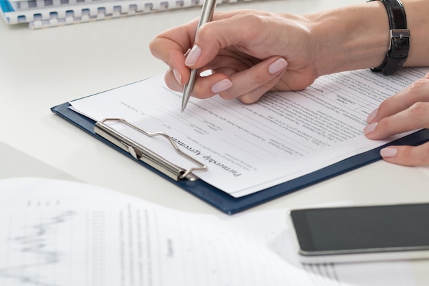 businesswoman filling partnership agreement form