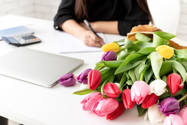 businesswoman florist writing in notebook