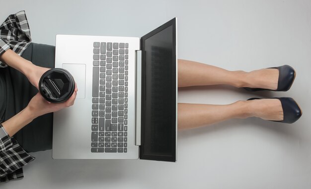 Businesswoman in formal clothes using laptop while sitting