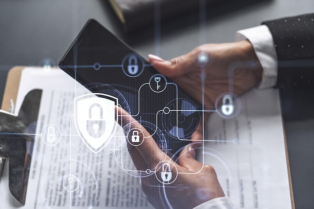 Photo a businesswoman in formal wear checking the phone to sign the contract to prevent probability of risks in cyber security padlock hologram icons over the working desk