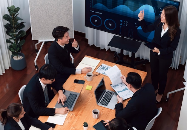 Businesswoman give presentation on dashboard data on screen at harmony office