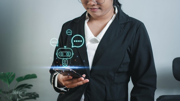 Businesswoman hand uses a smartphone to type live chat ask answer with an artificial intelligence system chat bot Ai