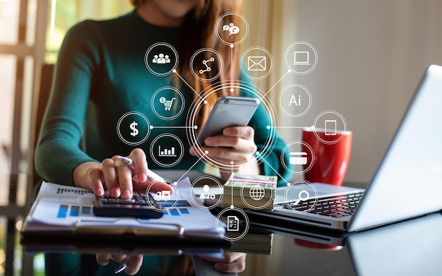 Businesswoman hand working with  laptop computer and tablet in modern office with virtual icon diagram