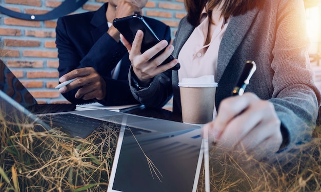 Businesswoman hand working with laptop computer tablet and smart phone in modern office with virtual icon diagram at modernoffice in morning light