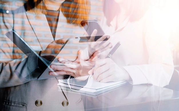 Businesswoman hand working with laptop computer tablet and smart phone in modern office with virtual icon diagram at modernoffice in morning light