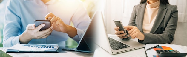 Businesswoman hand working with laptop computer tablet and smart phone in modern office with virtual icon diagram at modernoffice in morning light