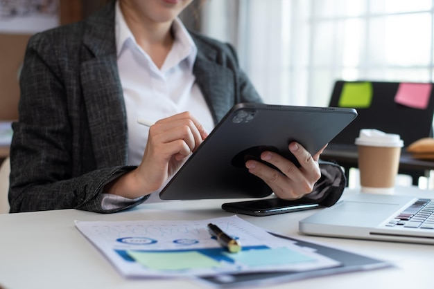 Businesswoman hand working with new modern computer using on smartphone and tablet as concept at office