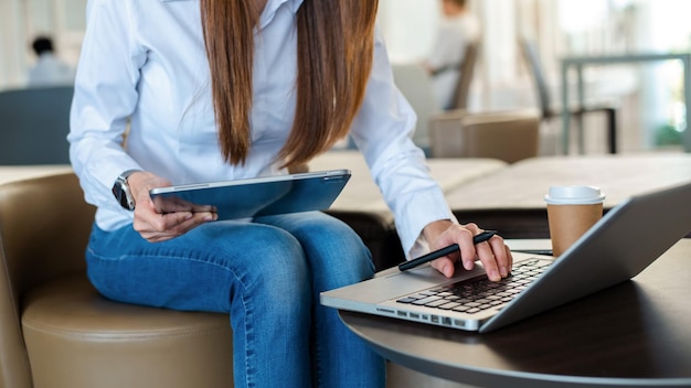 Businesswoman hand working with new modern computer using on smartphone and tablet as concept at officexA