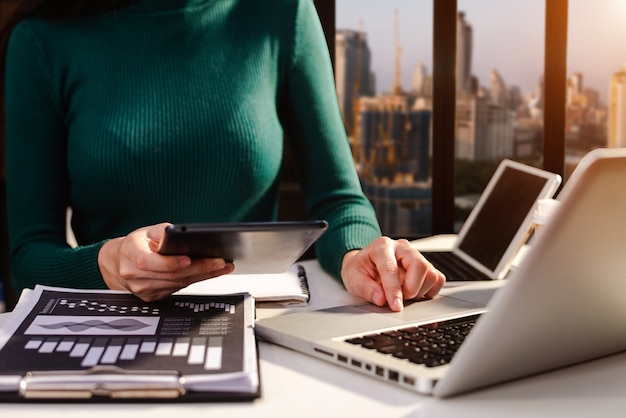 Businesswoman hand working with new modern computer using on smartphone and tablet as concept