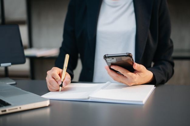 Businesswoman hand working with new modern computer using on smartphone and tablet as conceptxAxA