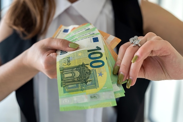 Businesswoman hands hold euro banknotes