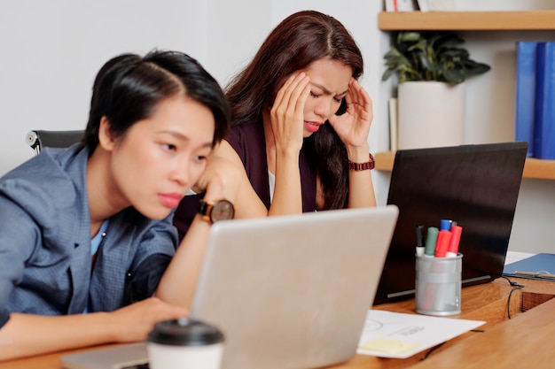 Businesswoman has a headache during work day