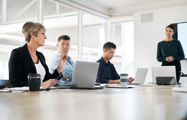 A businesswoman having a meeting in the boardroom with her team a female leader at a presentation