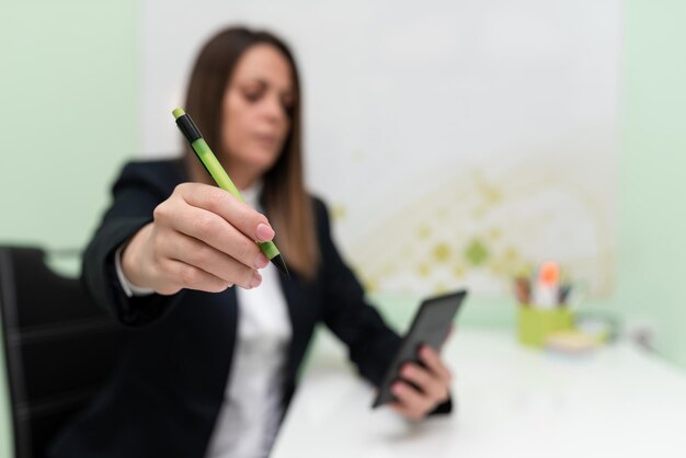 Businesswoman Having Tablet On Desk And Pointing Important Ideas With Pencil Woman With Phone Showing Recent Updates Executive Displaying Late News
