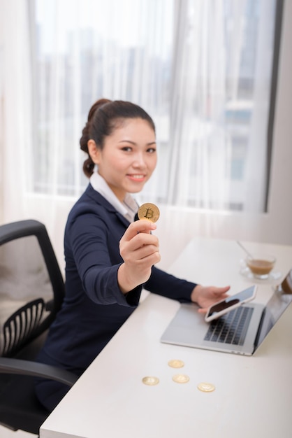 Businesswoman Holding Bitcoin in office, Digital Money and Bitcoin Concept.