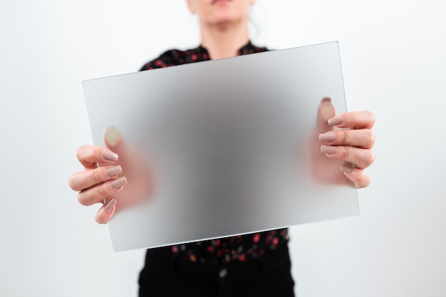 Businesswoman holding blank placard and making important\
announcement woman with rectangular board in hands presenting new\
ideas for advertising the business