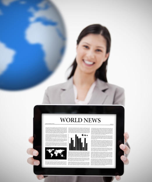 Businesswoman holding digital tablet showing world news