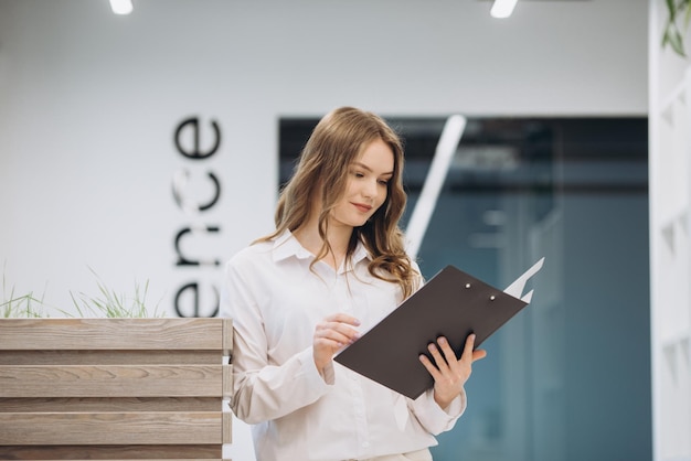 Businesswoman holding a document in an office