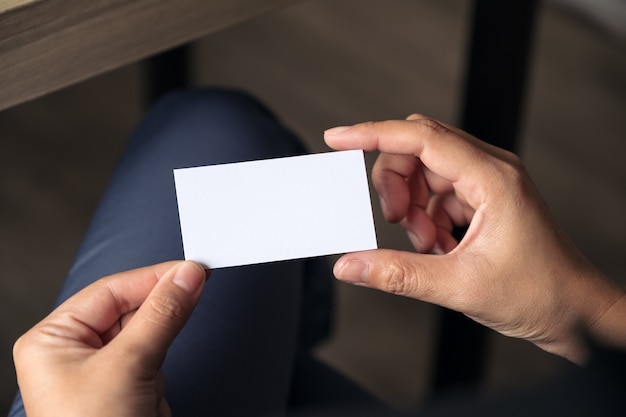 Businesswoman holding an empty business while sitting in office