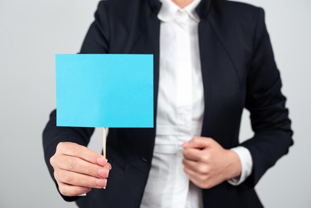 Businesswoman Holding Important Message On Paper Attached To Stick Woman Presenting Crutial Information Executive Displaying Critical Announcement