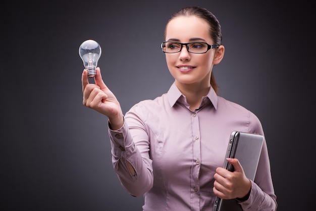 Businesswoman holding light bulb in creativity concept