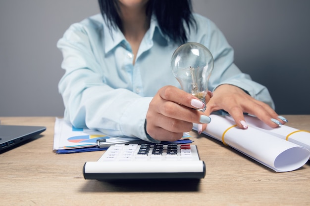 Businesswoman holding a light bulb