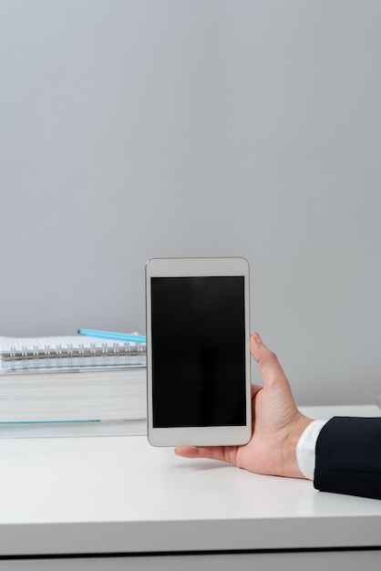 Businesswoman holding mobile phone and with important messages sitting woman in suit having