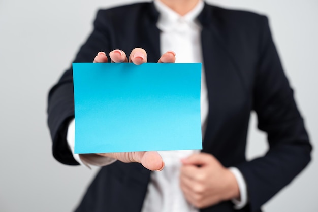 Businesswoman Holding Note With Important Message With One Hand Woman Presenting Crutial Information On Piece Of Paper Executive Showing Critical Announcement