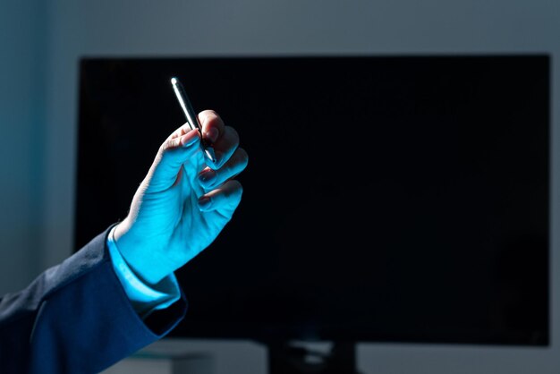 Businesswoman Holding Pen And Pointing On Important Messages On Table With Computer And Keyboard Woman Presenting Crutial Information With One Hand