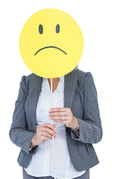 Photo businesswoman holding sad smiley face