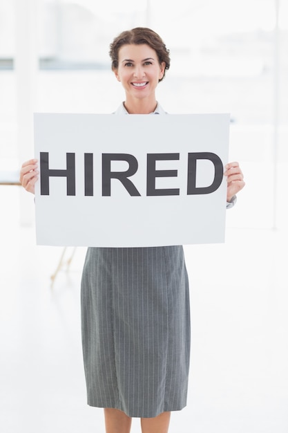 Photo businesswoman holding sign in front of her